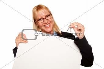 Attractive Blonde Holding Keys and Blank White Sign Isolated on a White Background.