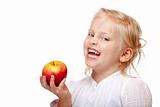 Child smiles happy with healthy apple in hand 