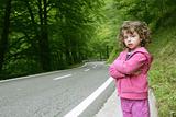 Cute little girl in a forest road 