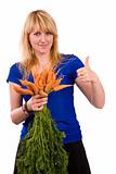 Girl holding bunch of carrots and shows OK