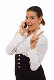 woman with victory gesture and mobile phone