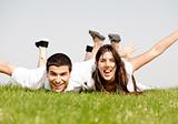 cute young Couple lie down on grass 