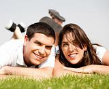 happy young Couple lie down on grass 