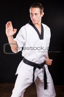 young man ready to fight on black with path
