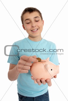 Boy dropping coin into money box