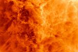 Close-up over a big explosion with nebulous orange flames