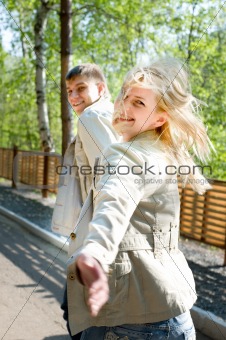 Young couple escaping and smiling