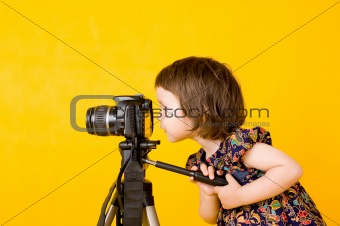 Baby girl holding photo camera