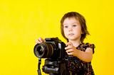 Baby girl holding photo camera