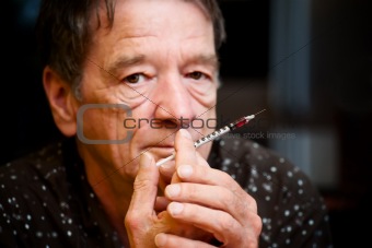 Man with small hypodermic needle