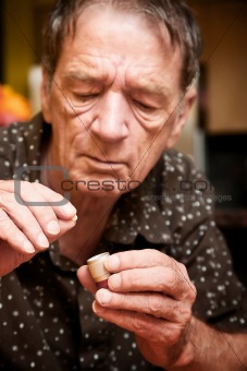 Man with small pill and case