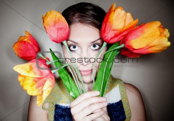 Girl Peeking Out from Behind Plastic Flowers