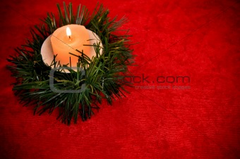 Burning candle with Christmas decorations