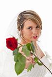 beautiful young bride in a wedding dress with a veil holding a rose