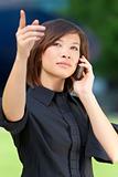 Beautiful Oriental Asian Chinese Woman On Cell Phone and Pointin