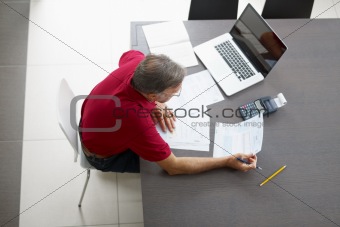 Senior man checking home finances