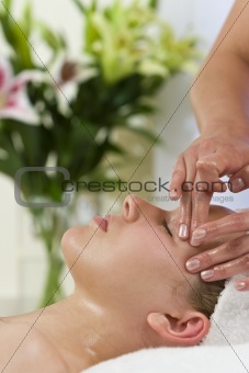 Beautiful Young Woman Having Facial Massage Treatment at Health 