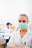 female dentist or dental assistant in office