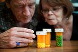 Senior couple examining medications
