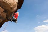 Young woman climbing a rock