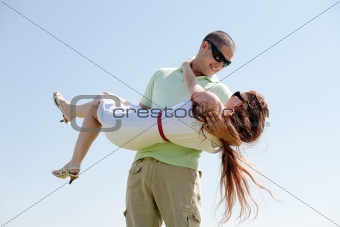 Young Guy Carrying His Girlfriend In His Arms