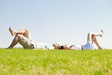 couple lie down on grass