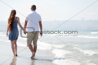  young couple walk at the beach