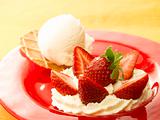 red dish with ice cream and strawberry