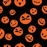 Seamless pattern with orange pumpkins on black background