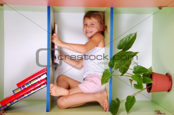 child reading a book in a bookcase