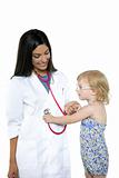Brunette pediatric doctor with blond little girl