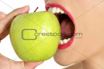 Apple macro on woman mouth detail of bite
