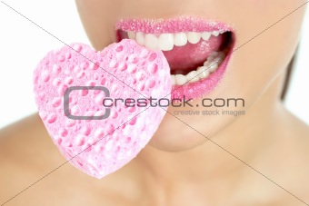 Heart shape sponge on woman macro mouth