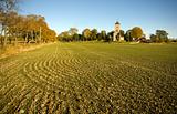 Plowed field and church