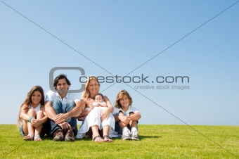 Family with kids and baby in field