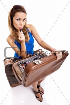 Traveller woman applying makeup