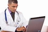 Medical doctor reviewing his notes on laptop