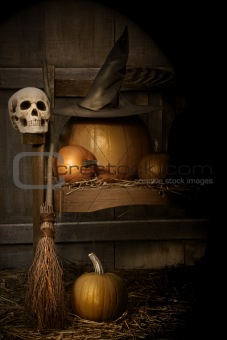 Big pumpkin with black witch hat and broom