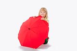 boy with long blond hair playing with a red umbrella