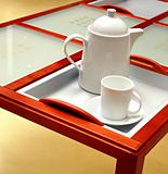 Tea pot and cup on a table
