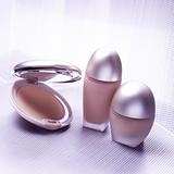 Three cosmetic objects on metallic background
