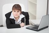 Resolutely woman - managing director sits at table with laptop