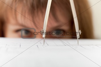 Compasses and drawing close up on face background