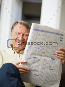 Senior man reading stock listings 