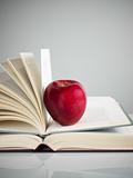 red apple on books