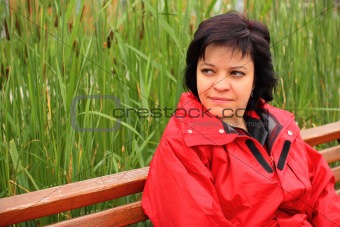 Woman sitting on wooden bench