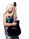 Teenage girl holding an acoustic guitar wearing jeans isolated on white