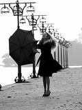 Blonde with umbrella on promenade