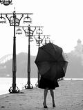 Lady with umbrella on promenade