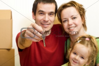 Happy family with the key of their new home